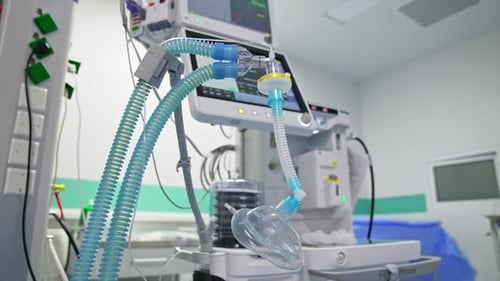 Blue tubes with oxygen mask for a patient breathing during operation.