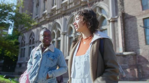 Girls Walking Outdoors on Campus and Discussing Study