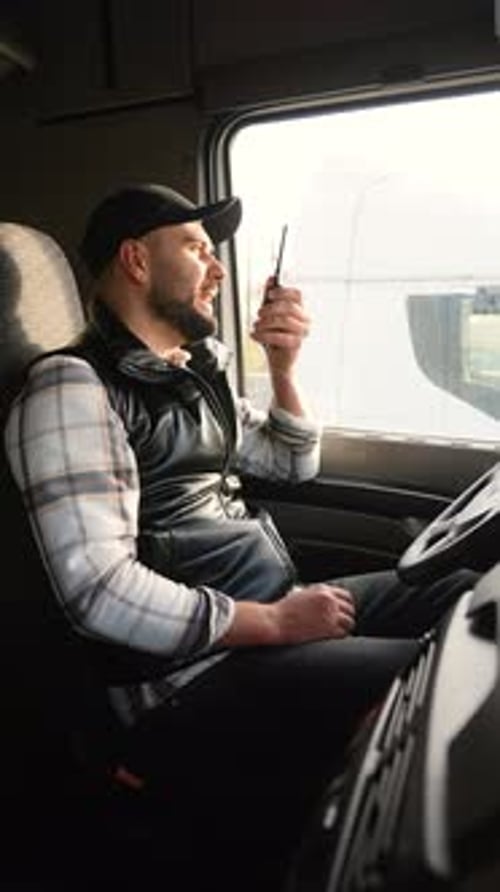 Truck Driver Communicating Using Walkie Talkie Radio