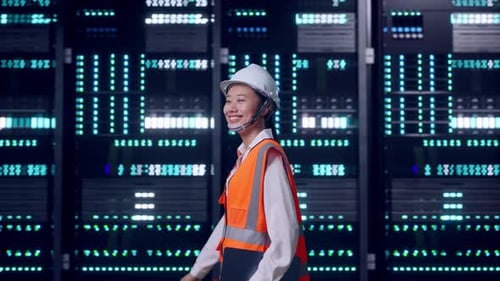 Asian Female Holding Tablet While Walking in Data Center