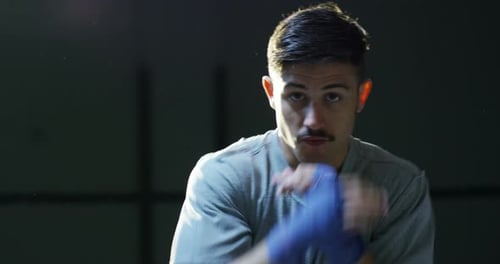 Professional young boxer in the ring, will practice the technique of strikes, struts, protection a
