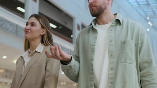Couple Walking along Shopping Mall Aisles