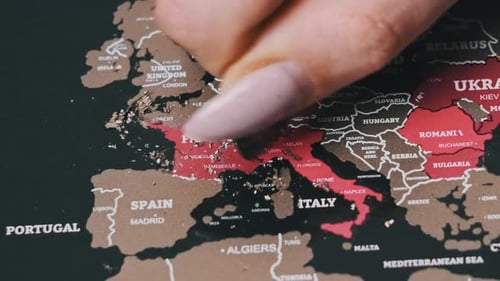 Female Hand Scratching France Country on the Surface of a Scratch World Map