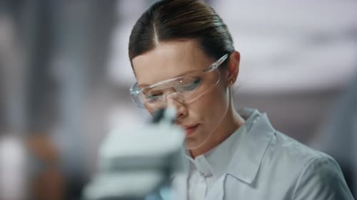 Woman Lab Worker Examining Test Tube