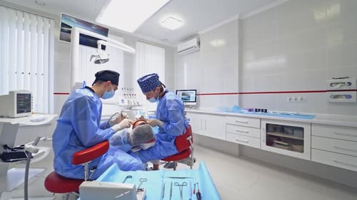 Dentists Performing Procedure in Modern Clinic