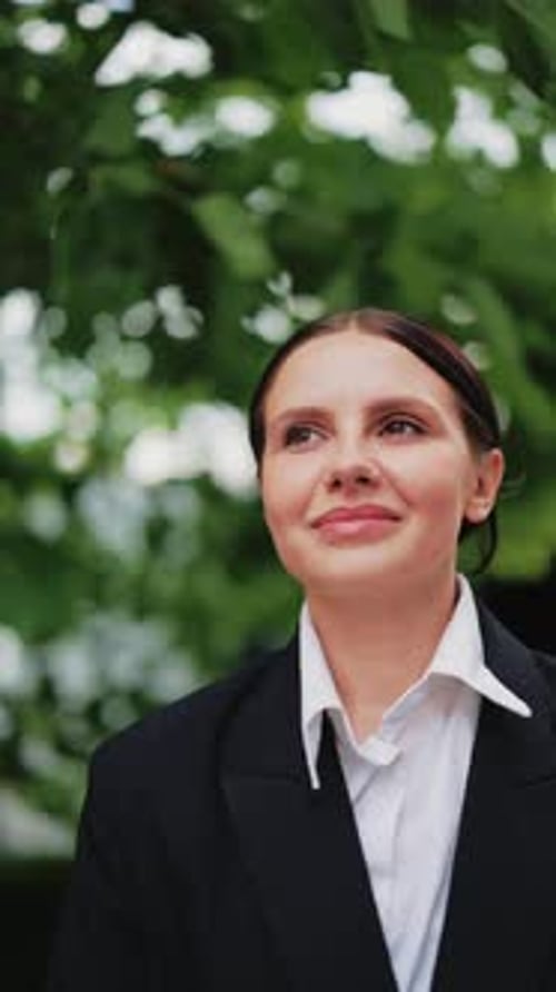 Femme d'affaires attentionnée souriante à l'extérieur