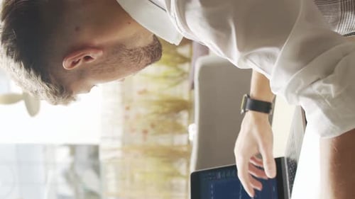 Businessman Sitting and Working in a Cafe Man Using Computer and Devices The Concept of Business and