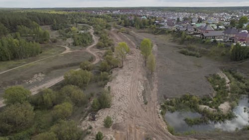 Ditch Prepared to Accommodate New Pipes Between Village and Forest