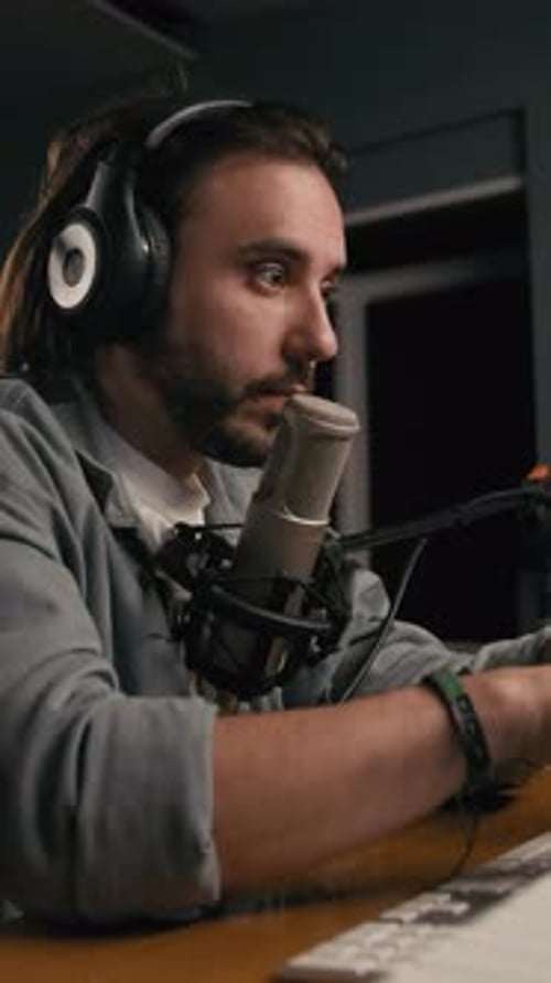 Man Speaking Into Microphone in Recording Studio