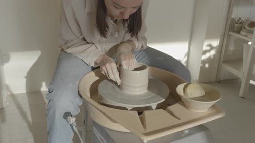 Young Woman Making Pottery on a Wheel