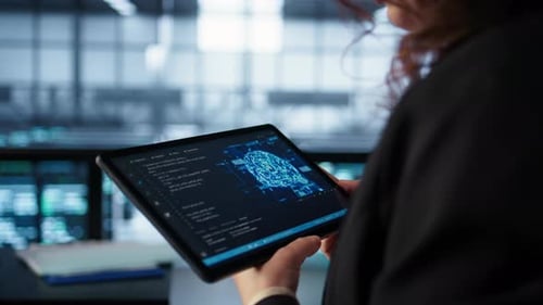 Data Center Technician Using Artificial Intelligence on Tablet Close Up