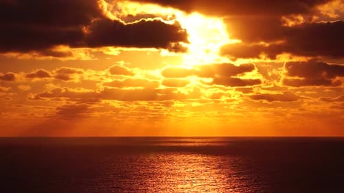Timelapse Dramatic Sunset with Fluffy Clouds Moving in Golden Burning Sky Over Sea Abstract Aerial