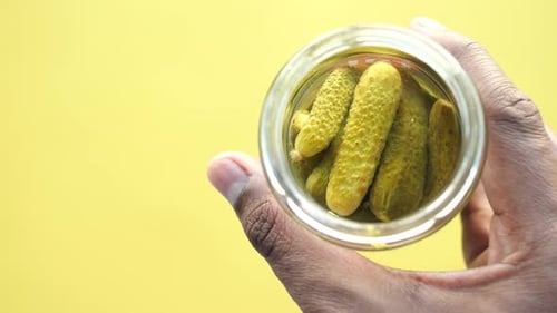 Bottle of Pickled Cucumbers Pickles on Table