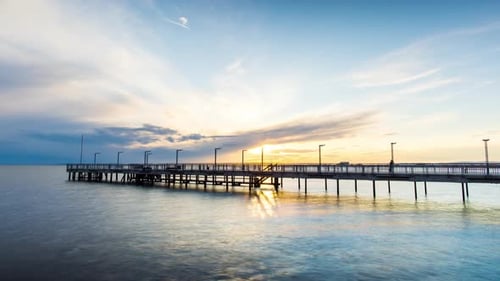 Side View of the Pier on the Black Sea Against the Background of the Sky and Sunset