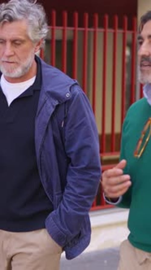 Stylish Senior Friends Walking and Talking Together Outdoors