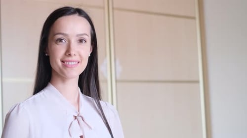 Portrait of a Young Brunette Business Woman Looking at the Camera