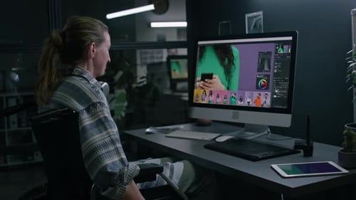 Woman Works on Computer in Wheelchair at Night