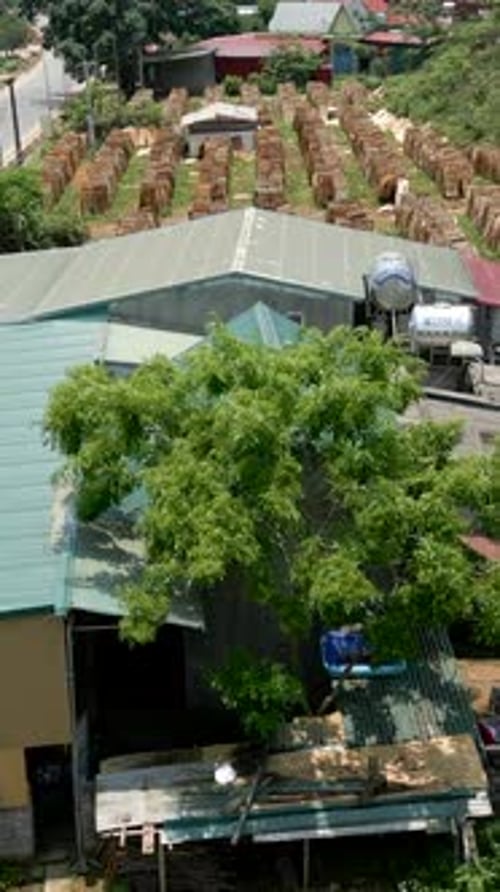Drone Flying Over the Road and Outdoor Wood Warehouse in a Rural Area in Vietnam