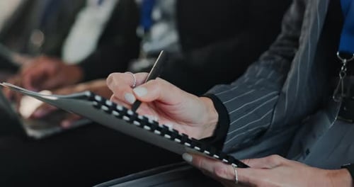 Woman Taking Notes During Conference