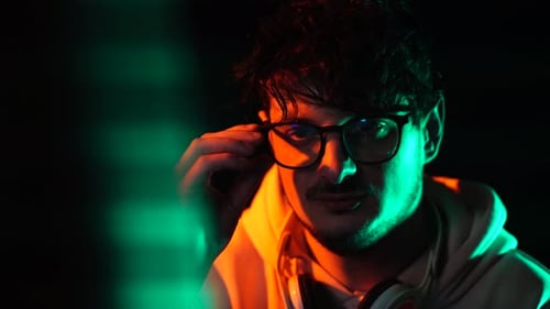 Young Adult with Headphones in Colored Lighting