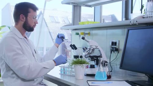 Scientist Using Pipette in Bright Laboratory Setting