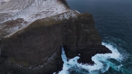 Aerial view of cliff meeting ocean, Faroe Islands.