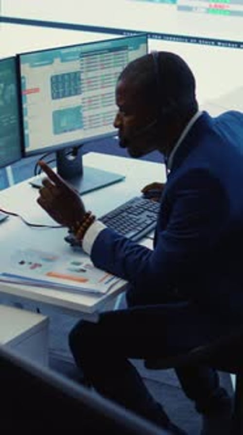 Vertical Video General Director Examining Statistics Big Data on Computer in a Control Room