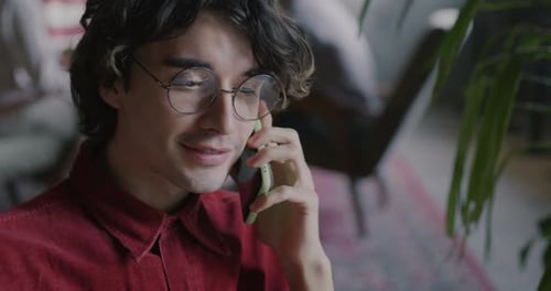 Young Adult with Glasses Talking on the Phone