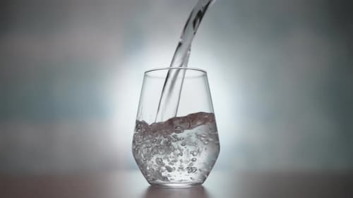 Water Pouring into a Clear Glass