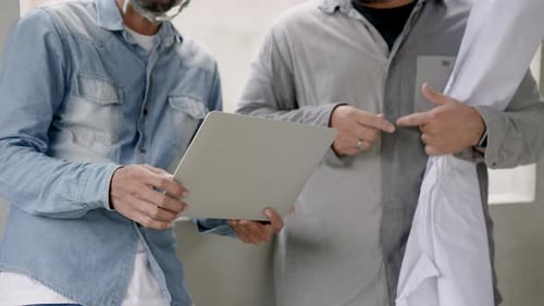 Male worker engineer construction supervisor and young Asian architect. holding laptop and holding s