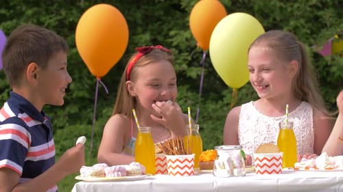 Children Enjoy Snacks at Fun Outdoor Birthday Party