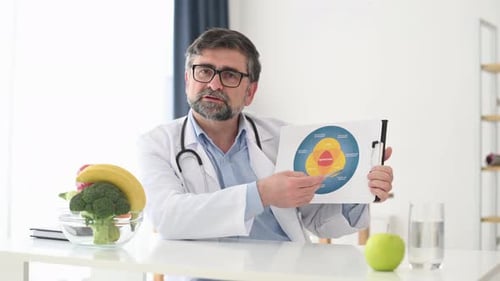 Doctor Explains Nutrition Diagram with Fresh Fruit