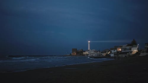 Lighthouse on the Beach in the Night