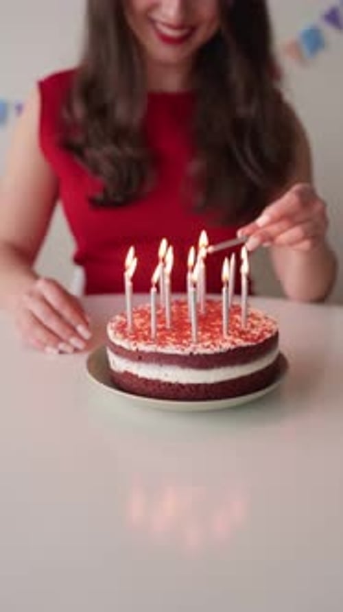 Woman Lights Candles on Birthday Cake Indoors