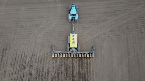 Blue tractor OA working on the field in Ukraine