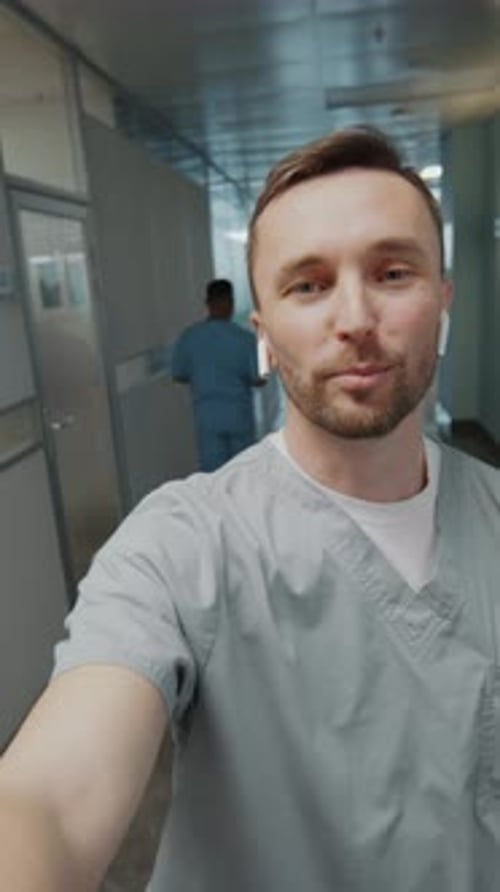 POV of Hospital Worker Walking in Corridor and Speaking on Camera