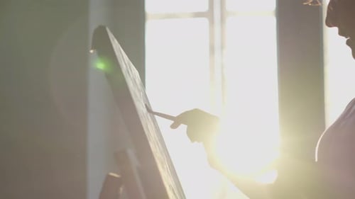 Artistic Talent with Refined Taste in the Photo a Young Artist in the Studio Draws Beautiful Works