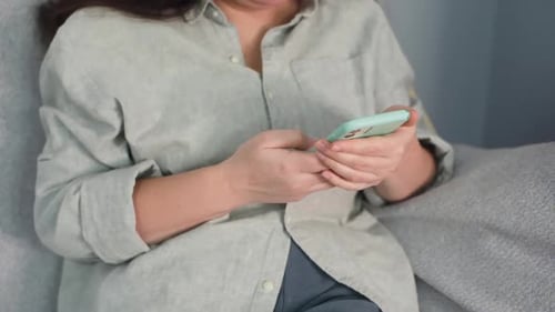 Woman Using Smartphone Device Indoors