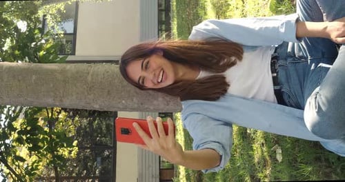 Smiling Woman Using Phone Outdoors