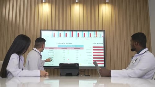 Medical Professionals Discussing Patient Data in Office