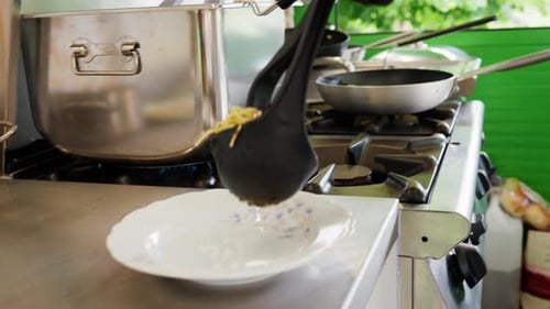 Chef Plates Spaghetti in Professional Kitchen