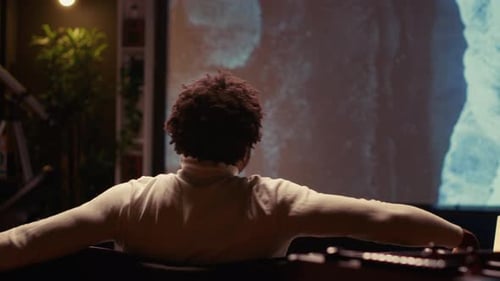 Adult Watching a Screen Indoors at Night