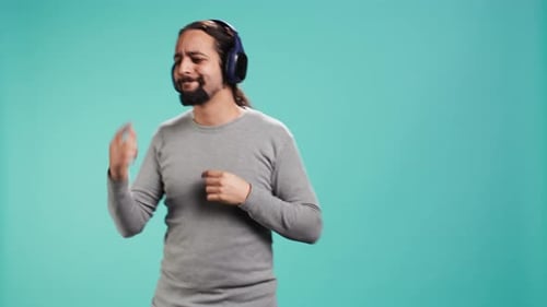 Man With Headphones Dancing and Grooving to Music