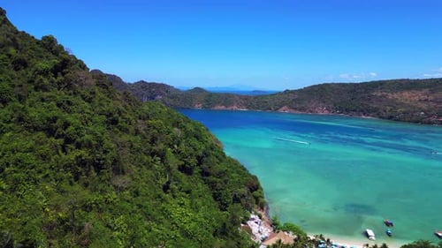 Turquoise blue sea Cliffs Rocks island hill beach. Perfect aerial top view flight
dolly left drone