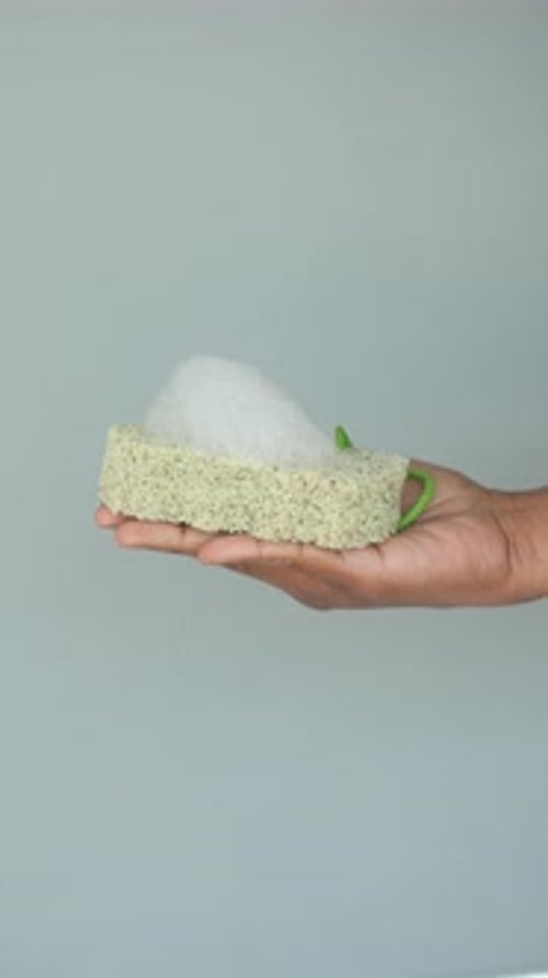 Hand Holding Loofah With Foam
