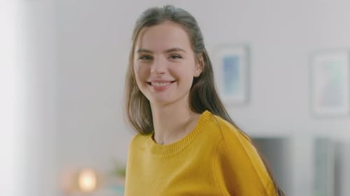 Attractive Young Woman Smiling in Bright, Modern Interior