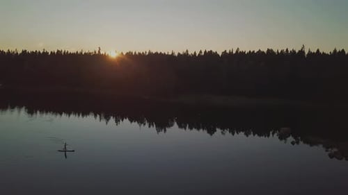 Silhouette Person on SUP – Stand Up Paddle Board, late summer night in Kvarken, Finland, Northern Eu