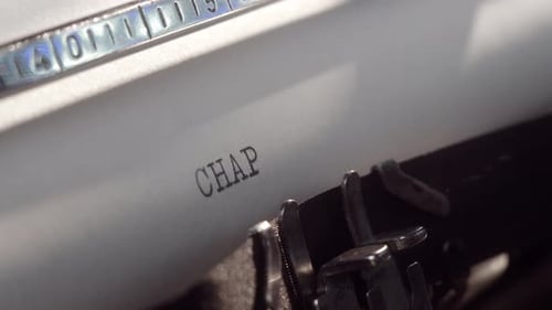 Writer Types Chapter Five on a Typewriter in a Cozy Home Office Setting During Afternoon
