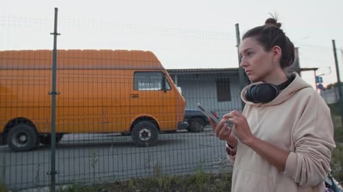 Woman Using Smartphone in Urban Setting