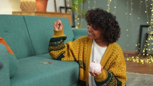 Saving Money Investment for Future African American Girl Holding Pink Piggy Bank and Putting Money